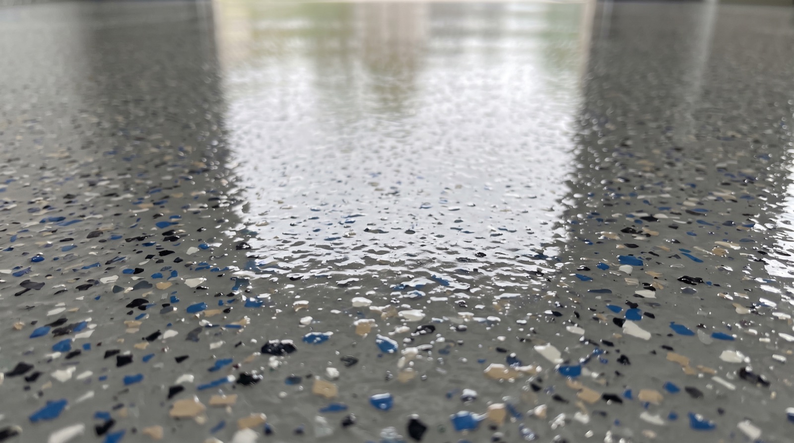 Close-up texture of a glossy polyaspartic garage floor coating